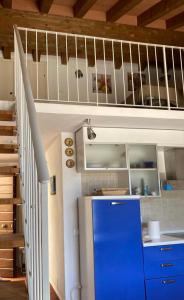 a kitchen with a blue refrigerator and a staircase at Sea View Apartment in Capraia