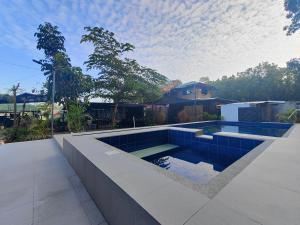 a swimming pool in the middle of a yard at Bacnotan, La Union Private Resort - Teresa Kazza Resort in Bacnotan