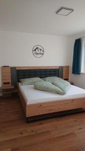 a bedroom with a large wooden bed with white sheets at Anni, Apart in Tux