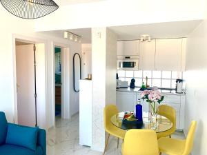 eine Küche und ein Esszimmer mit einem Tisch und gelben Stühlen in der Unterkunft Arilvia good vibes only in Costa Calma
