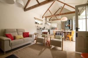 a living room with a couch and a table at Lambriggan Court in Perranzabuloe