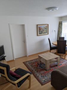 a living room with a couch and a table at Schiablick - Broggini in Davos