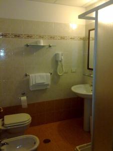a bathroom with a toilet and a sink at Hotel San Pietro in Rome