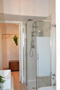 a bathroom with a shower and a toilet and a sink at B&B Fashion style in Cagliari