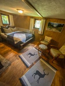 an aerial view of a bedroom with a bed and chairs at Chalet Wildalpen (in Ruhelage & mit Wellness) in Wildalpen