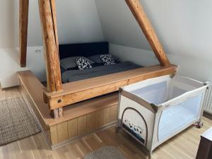 a small bed in a room with a staircase at U Lupka - Ostrava in Ostrava