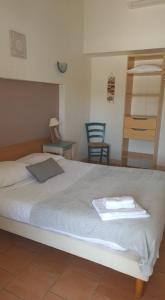 a bedroom with a large bed with a tray on it at Le Relais Des Lavandins in Le Muy