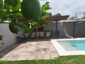 a patio with a pool and a table and chairs at Pueblo Maschwitz in Ingeniero Maschwitz