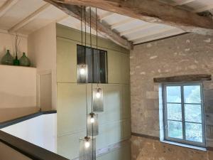 une cuisine avec un lustre suspendu au plafond dans l'établissement Loire Valley village centre apartment chezANIA, à Le Grand-Pressigny