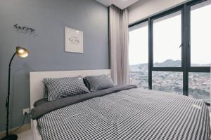 a bedroom with a bed with a view of a city at Mini House Gombak 2BR 5pax Ayuman Suites in Kuala Lumpur +34 photos