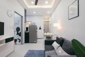 a living room with a couch and a refrigerator at Mini House Gombak 2BR 5pax Ayuman Suites in Kuala Lumpur