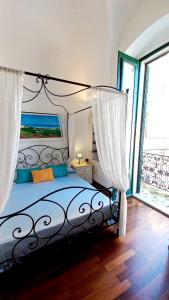 a bedroom with a bed with a large window at Il Pregio in Ostuni