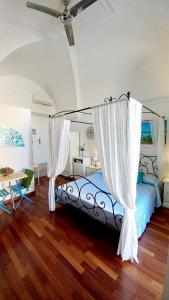 a bedroom with a bed with a canopy at Il Pregio in Ostuni