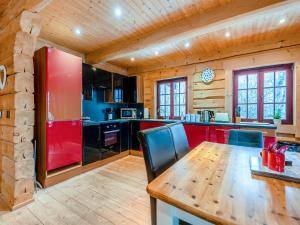 a kitchen with a wooden table and a red refrigerator at Ty Afal - Uk42099 in Carno