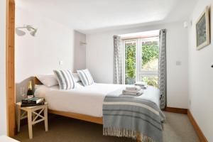 a bedroom with a large bed with a window at Sundeck in Brixham