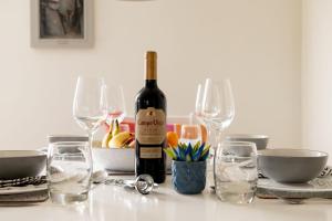 a bottle of wine sitting on a table with glasses at Sundeck in Brixham +6 photos