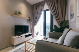 a living room with a couch and a television at Muji Home 2BR 4Pax Southlink Nexus Bangsar South in Kuala Lumpur