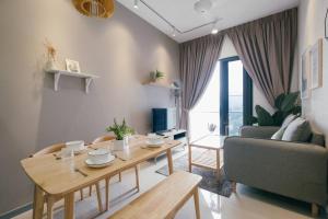 a living room with a table and a couch at Muji Home 2BR 4Pax Southlink Nexus Bangsar South in Kuala Lumpur