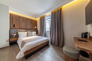a hotel room with a bed and a window at Casa Nou in Mexico City