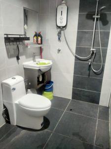 a bathroom with a toilet and a sink at Beaufort Paguyut Homestay in Beaufort