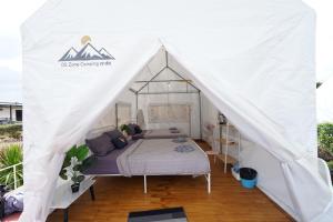 a canopy bed in a white tent at Yellowstone Camps O2 Zone Khao Kho in Khao Kho