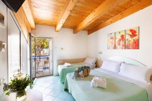 Cette chambre comprend deux lits et un balcon. dans l'établissement Hotel Caprice - in centro a Riccione, à Riccione