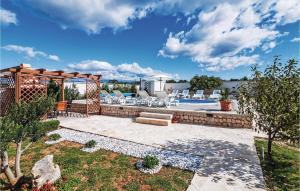 a backyard with a pool and a pergola at Luxurious Home In Vrsi in Vrsi
