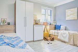 a bedroom with two beds and a closet at Apartmány a Wellness VMAL s.r.o. in Skuteč