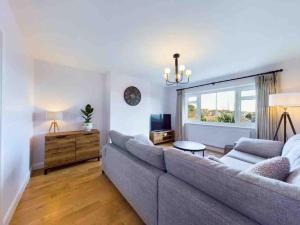 a living room with a couch and a window at Broadstairs Beach Bungalow. Dogs welcome! in Broadstairs