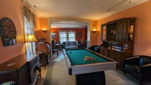 a living room with a pool table in it at Garden and Sea Inn in New Church