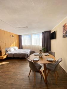 a hotel room with a table and a bed at El Patio Hostal in Alicante +103 photos