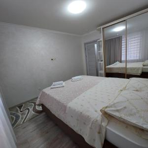 a bedroom with a bed and a large mirror at Apartament lux new in Chişinău