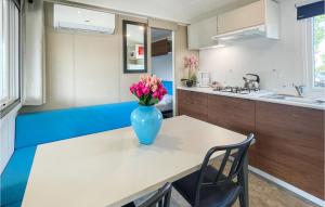 a vase of flowers sitting on a table in a kitchen at Pet Friendly Stacaravan in Tuoro sul Trasimeno