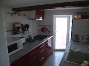 a kitchen with a stove top oven next to a door at Maison Provence à Baudinard-sur-Verdon in Baudinard