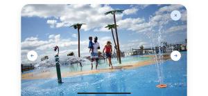 a group of people standing in a pool at a resort at Holiday Lodge 6 in Porthcawl
