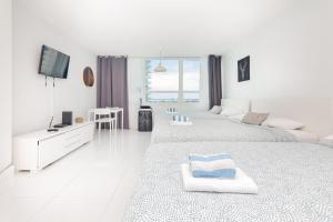 Postel nebo postele na pokoji v ubytování Girasole Apartments