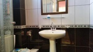 a bathroom with a sink and a mirror and a toilet at Kanali Beach House in Kanali +35 photos