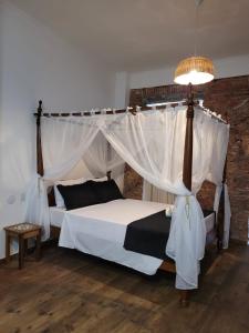 a bedroom with a bed with a canopy at Pelourinho Boutique Hotel - OH HOTÉIS in Salvador