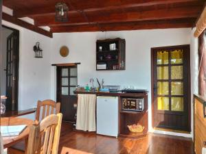 a kitchen with a white refrigerator and a table at Casa Rural "La Molina" in Máguez