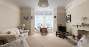 a living room with a couch and a fireplace at Marina View Brixham in Brixham