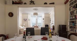 a dining room with a table with wine glasses at Marina View Brixham in Brixham