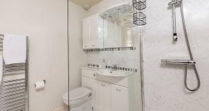 a bathroom with a toilet and a sink and a shower at Marina View Brixham in Brixham +15 photos
