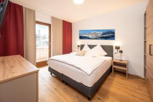 a hotel room with a bed and a window at Kuckuck Hinterthal - Appartements in Hinterthal