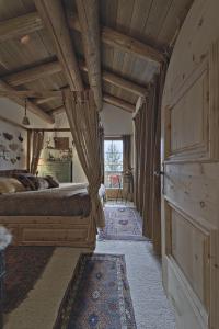 a bedroom with a large bed and a wooden ceiling at Chesa Brunzigna - Zuoz in Zuoz