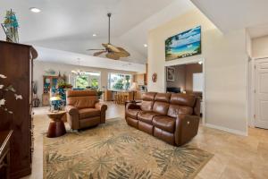 a living room with a couch and a chair at Big Island Awamoa Hale home in Waikoloa