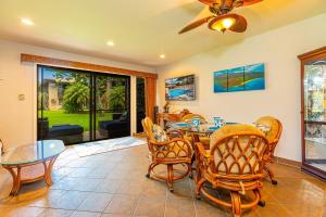 a dining room with a table and chairs at Kihei Garden Estates D104 condo in Kihei