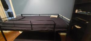 a bedroom with a bunk bed with purple sheets at Zen Hostel in Toronto