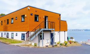 a building with an orange roof on top of it at Puffin 4 - The Cove in Brixham