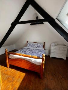 a bedroom with a wooden bed in a attic at Maison de Maison in Maël-Pestivien +12 photos
