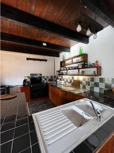 a kitchen with a sink and a counter top at Maison de Maison in Maël-Pestivien +12 photos